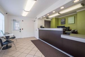 a waiting room with a counter and chairs in a room at Studio 6 Extended Stay - Roswell, GA - Atlanta in Roswell