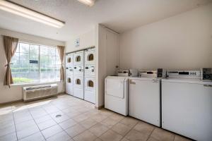 a laundry room with white appliances and a window at Studio 6 Extended Stay - Roswell, GA - Atlanta in Roswell