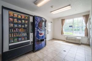 a large soda vending machine in a room at Studio 6 Extended Stay - Roswell, GA - Atlanta in Roswell