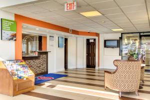 an office lobby with an exit sign on the wall at Motel 6-Washington, DC in Washington, D.C.