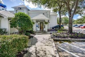 a white building with a yellow door at Studio 6-Houston, TX - Hobby South in Houston