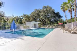 a swimming pool with chairs and a fence at Studio 6 Extended Stay - Kissimmee, FL - Orlando in Orlando