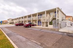 a building with cars parked in a parking lot at Ocean Inn South Padre Island in South Padre Island