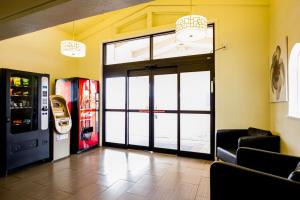 a lobby with a door and a soda machine at Motel 6-Austin, TX - Midtown in Austin
