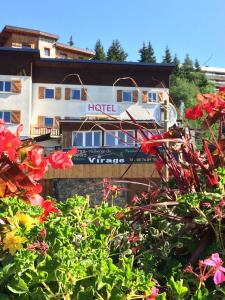 a hotel with a boat in front of a building at Auberge du Virage in Chamrousse