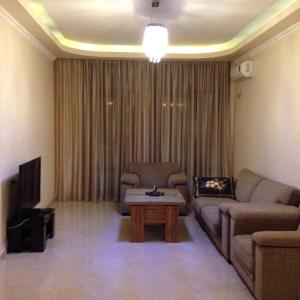 a living room with a couch and a coffee table at 11 Shio Chitadze St in Tbilisi City