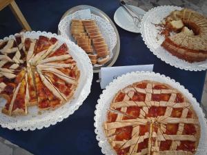 a blue table topped with pies and other desserts at Hotel Eden in San Domino