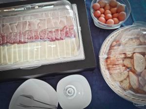 a table with eggs and meat and other foods on it at Hotel Eden in San Domino