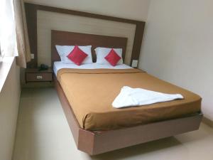 Ένα ή περισσότερα κρεβάτια σε δωμάτιο στο Banyan Tree Comforts Mysore