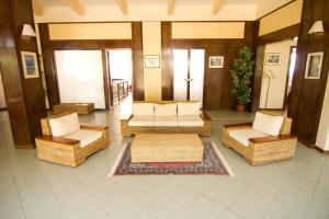 a lobby with couches and chairs in a building at Hotel Eden in San Domino
