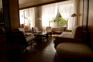 a living room with a couch and a table and chairs at Hotel Eden in San Domino