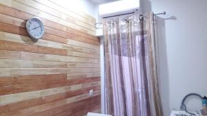 a bathroom with a wooden wall with a clock on it at Sharel in Msida +15 photos