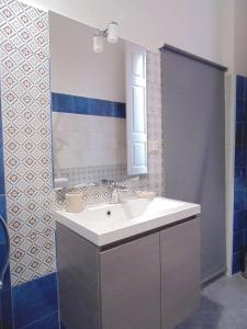 a bathroom with a sink and a mirror at Casa Polena in Catania
