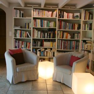 two chairs in a living room with bookshelves at Couleur Lavande in Le Thor