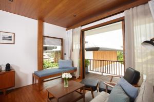 a living room with a couch and a table at Chann Bangkok Noi in Bangkok +66 photos