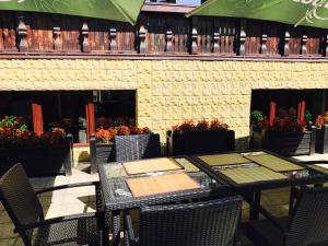 a table and chairs on a patio with flowers at Casa Frent in Predeal