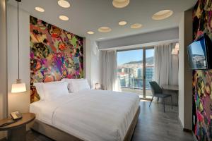 a hotel room with a bed and a window at Athens Tiare by Mage Hotels in Athens