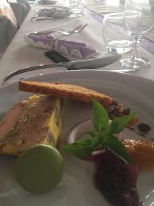 a white plate with food on a table at Hotel Belvue in Sault-de-Vaucluse