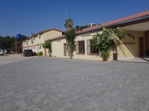 an empty parking lot in front of a building at Rocha's Hotel in Oshakati