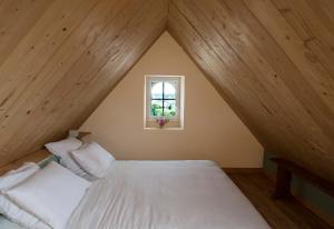 a bedroom with a white bed and a window at Le Pilleur d'Epaves in Cléden-Cap-Sizun