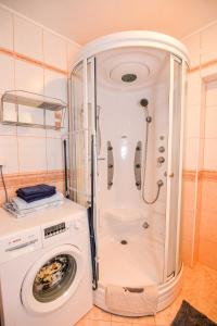 a washing machine and a washer in a bathroom at Nidos Laivas in Nida
