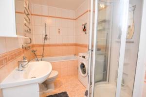 a bathroom with a sink and a toilet and a shower at Nidos Laivas in Nida +16 photos