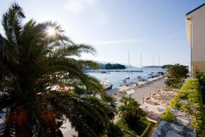 a view of a beach with boats in the water at Hotel International in Rab