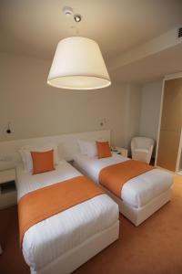 Postel nebo postele na pokoji v ubytování Hotel Bulqiza