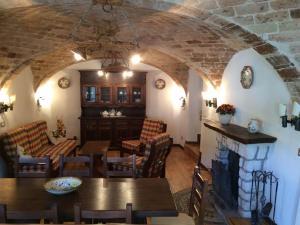 a living room with a table and a fireplace at Casa Laura in Castel del Monte