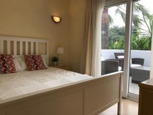 a bedroom with a bed and a balcony at Camino del Vasco in Denia +28 photos