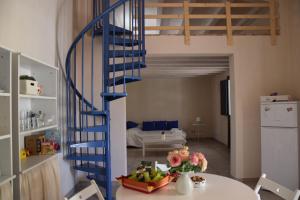 a blue spiral staircase in a living room at Tempo Di Vendicari in La Banca