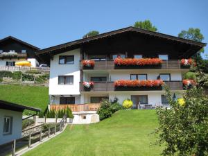a building with flower boxes on the side of it at Appartements Bachler in Brixen im Thale
