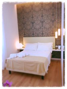 Sanremo Luxury Suites tesisinde bir odada yatak veya yataklar