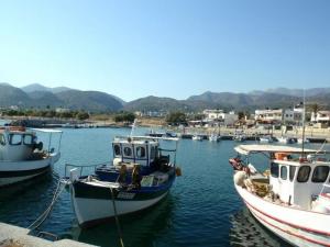 a group of boats docked in a harbor at Kiveli in Milatos