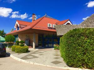 a house with a red roof and a driveway at Hotel "Księżyc" w Świebodzicach in Świebodzice