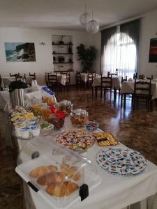 a table filled with different types of bread and pastries at B&B HF Fiorella in Maratea