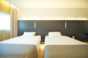 Posteľ alebo postele v izbe v ubytovaní Mercure Nerocubo Rovereto