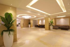 a lobby of a hotel with couches and plants at Minh Tam Hotel & Spa 3/2 in Ho Chi Minh City