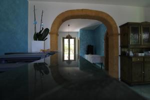 a kitchen with an archway in a room with blue walls at B&B Villa Bea in San Vito lo Capo