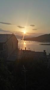 a sunset over a body of water with a building at Il nido dei Gabbiani in Portovenere