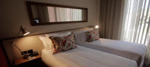 a hotel room with two beds and a mirror at Cottage Puerto Buceo in Montevideo +78 photos