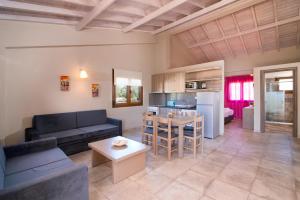 a living room with a couch and a table at Olive Land Villas in Limenaria