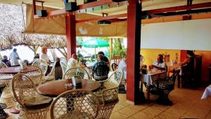 a group of people sitting at a table in a restaurant at The Boat House in Boca Chica