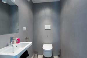 a bathroom with a white toilet and a sink at Villa Stella Cadente in Serranova +26 photos