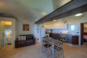 a kitchen and living room with a table and a couch at Crosa tra le Nuvole in Borgio Verezzi