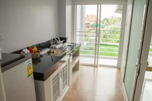 a kitchen with a sink and a counter at Charisma Residence in Rayong