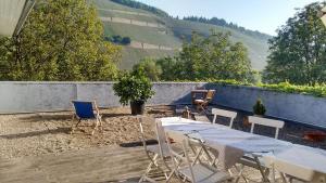 a table and chairs on a patio with a view at Weingut Fehres in Brauneberg