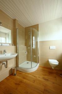 a bathroom with a shower and a sink and a toilet at Weingut Fehres in Brauneberg