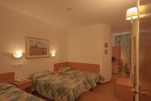 Postel nebo postele na pokoji v ubytování Hotel Tirreno