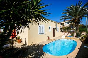 a large swimming pool in front of a house at Casa Heidi in Cala Santanyi